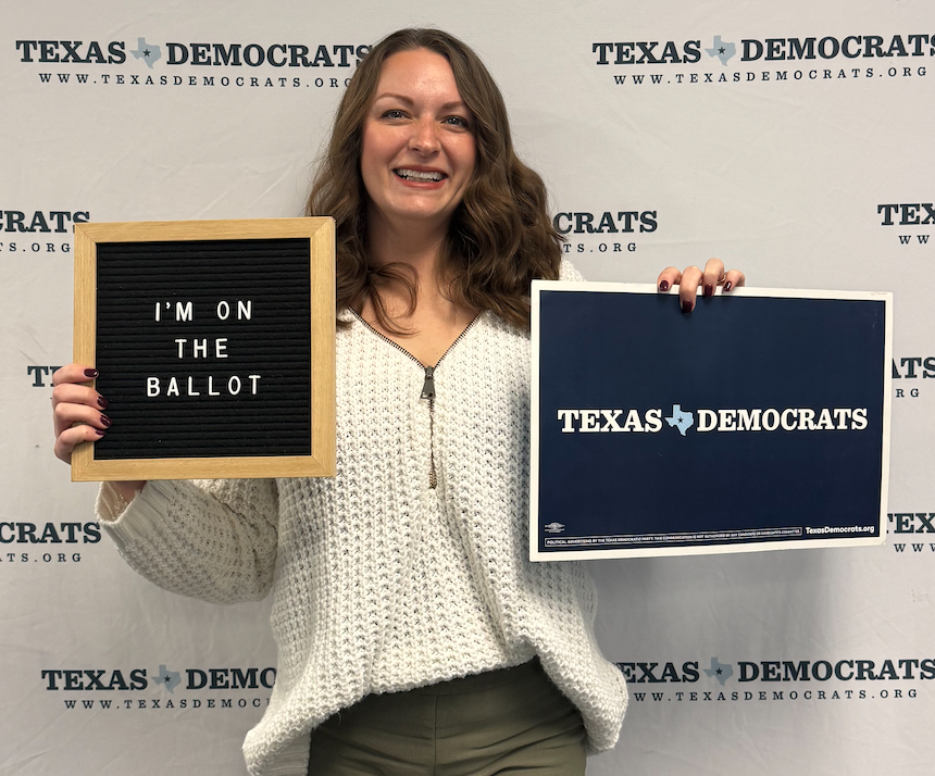 Chelsey Hockett holding a plaque that says 'Registered Democrat'